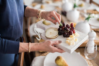 White mini charcuterie board at dinner party