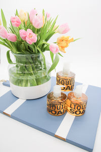 Clear vase with white bottom on serving board