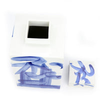 Open blue and white square tea jar