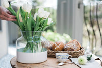 Clear and white colorblock vase with flowers on porch