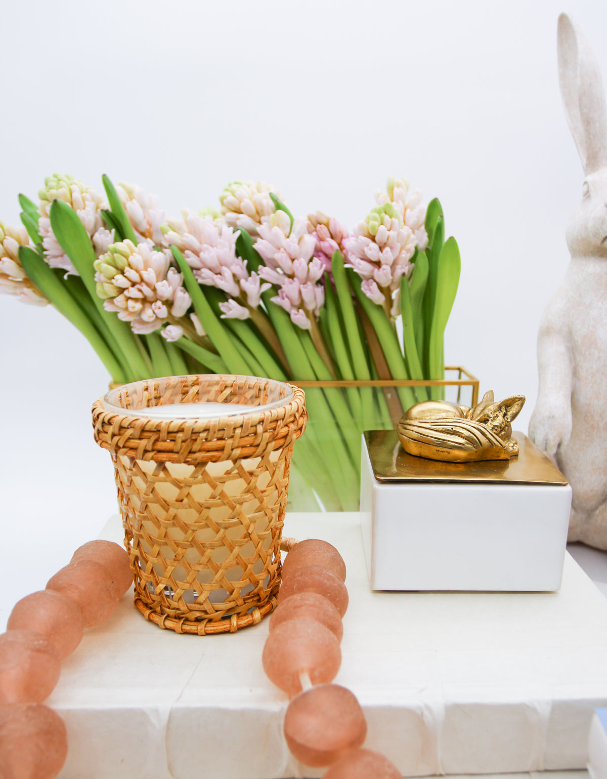 Clear glass rectangular vase with gold metal trim on table