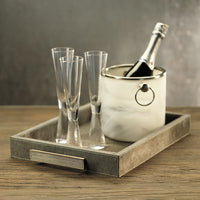 Decorative tray with alabaster ice bucket and champagne glasses